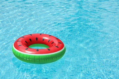 Inflatable ring floating in pool on sunny day