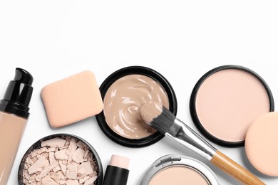 Photo of Foundation, beauty accessories and face powders on white background, flat lay. Space for text