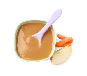 Photo of Tasty baby food in bowl, spoon, cut apple and carrots isolated on white, top view