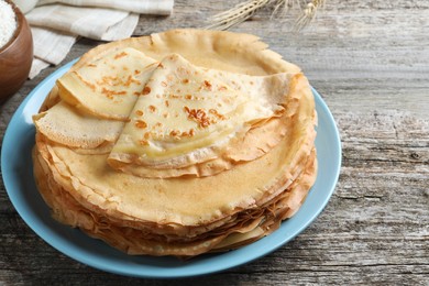 Photo of Stack of delicious crepes on wooden table