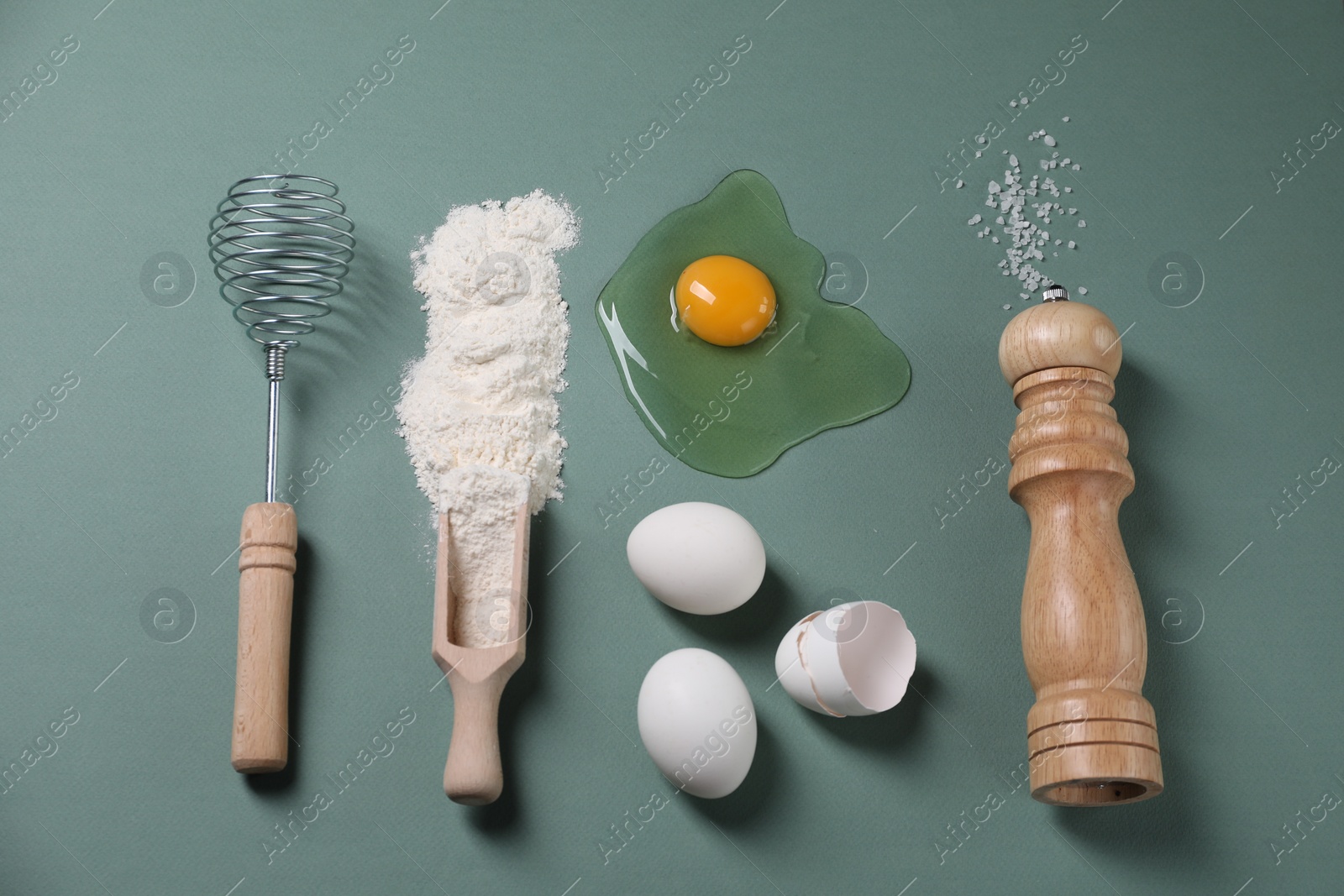 Photo of Flat lay composition with whisk and dough ingredients on pale blue background