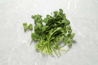 Photo of Fresh green cilantro on light grey marble table, flat lay