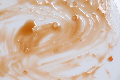 Photo of Smear of sauce on white background, top view