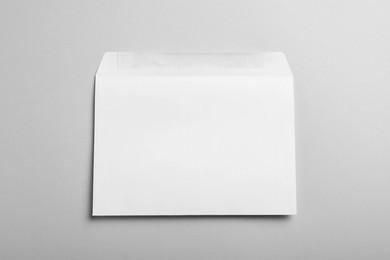 White paper envelope on light grey background, top view