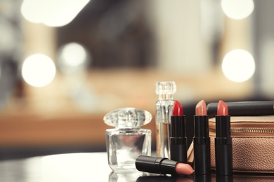Photo of Decorative cosmetics on dressing table in makeup room, closeup
