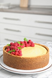 Photo of Dessert plate with delicious raspberry cake on marble table indoors. Space for text