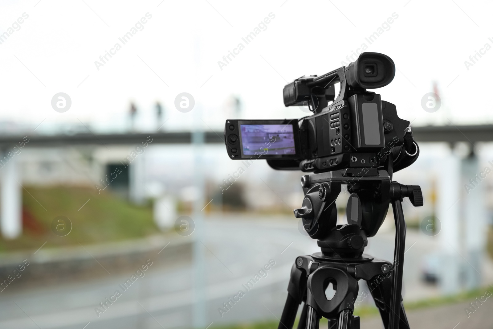 Photo of Professional video camera outdoors. Space for text