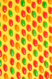 Flat lay composition with delicious jelly beans on color background