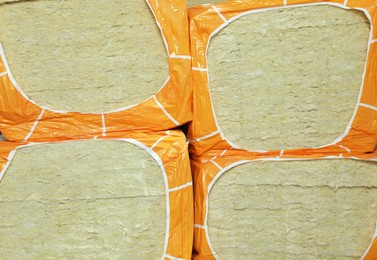 Photo of Packages of thermal insulation material as background