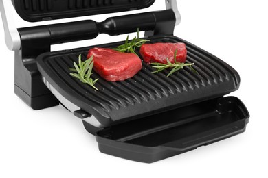 Electric grill with raw meat steaks and rosemary isolated on white