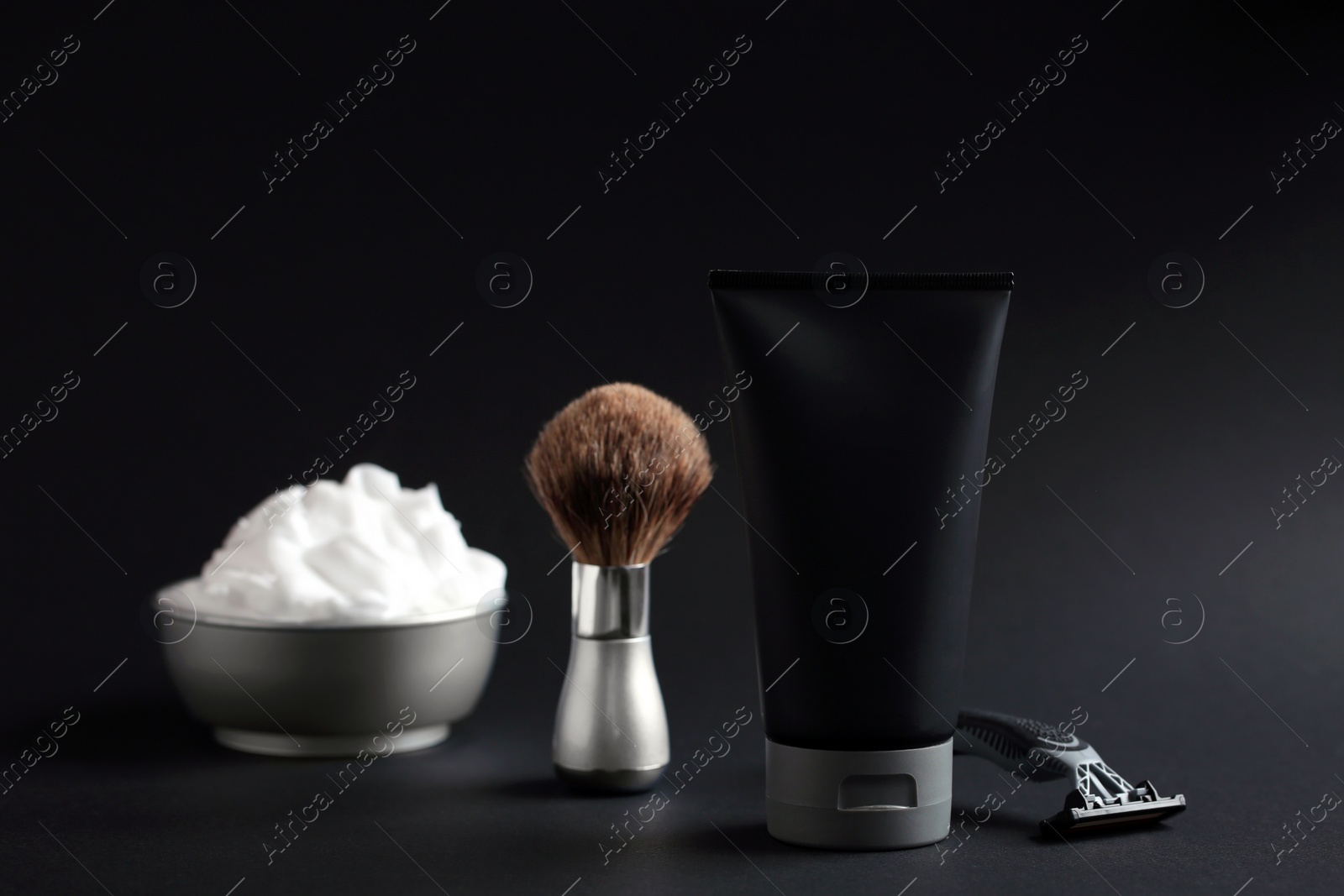 Photo of Set of shaving equipment and men's cosmetic products on black background