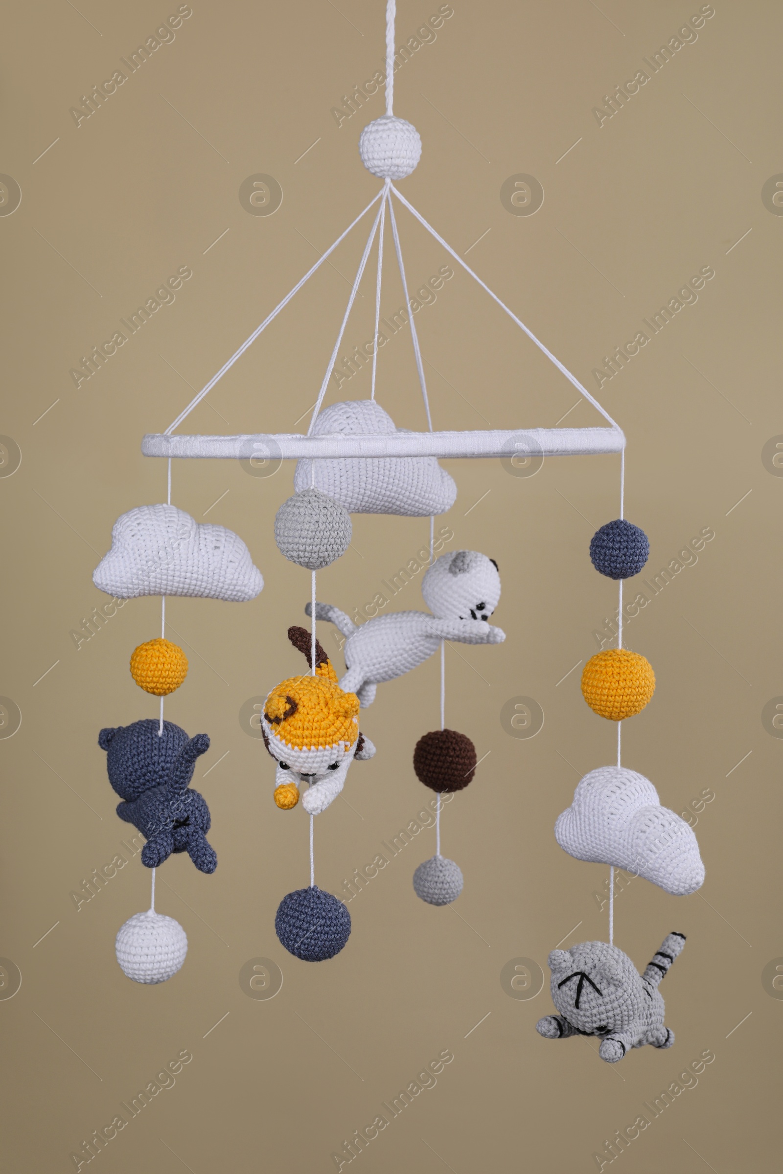 Photo of Cute baby crib mobile on beige background