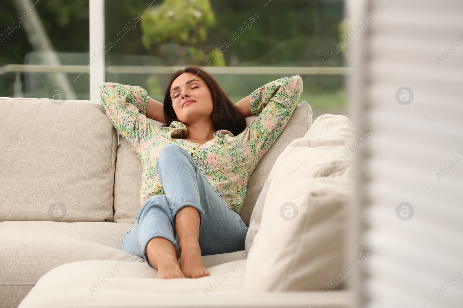 Photo of Young woman sleeping on sofa at home