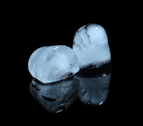 Photo of Melting ice cubes on black background. Frozen liquid