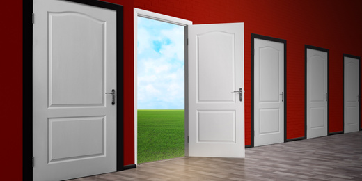 Image of One open door among closed ones in room. Concept of choice