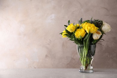 Beautiful bouquet with peony tulips on table against grey background, space for text