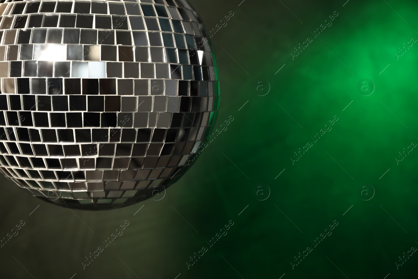 Photo of Shiny disco ball on dark background, closeup. Space for text