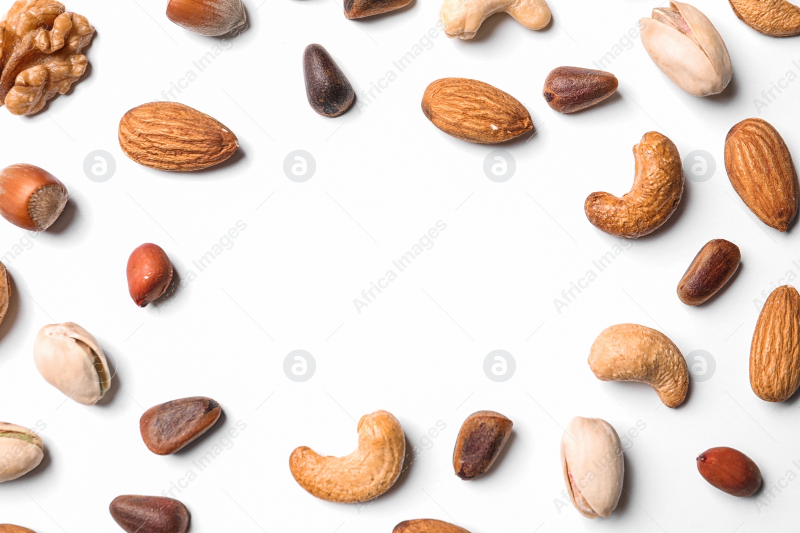 Photo of Composition with organic mixed nuts on white background, top view. Space for text