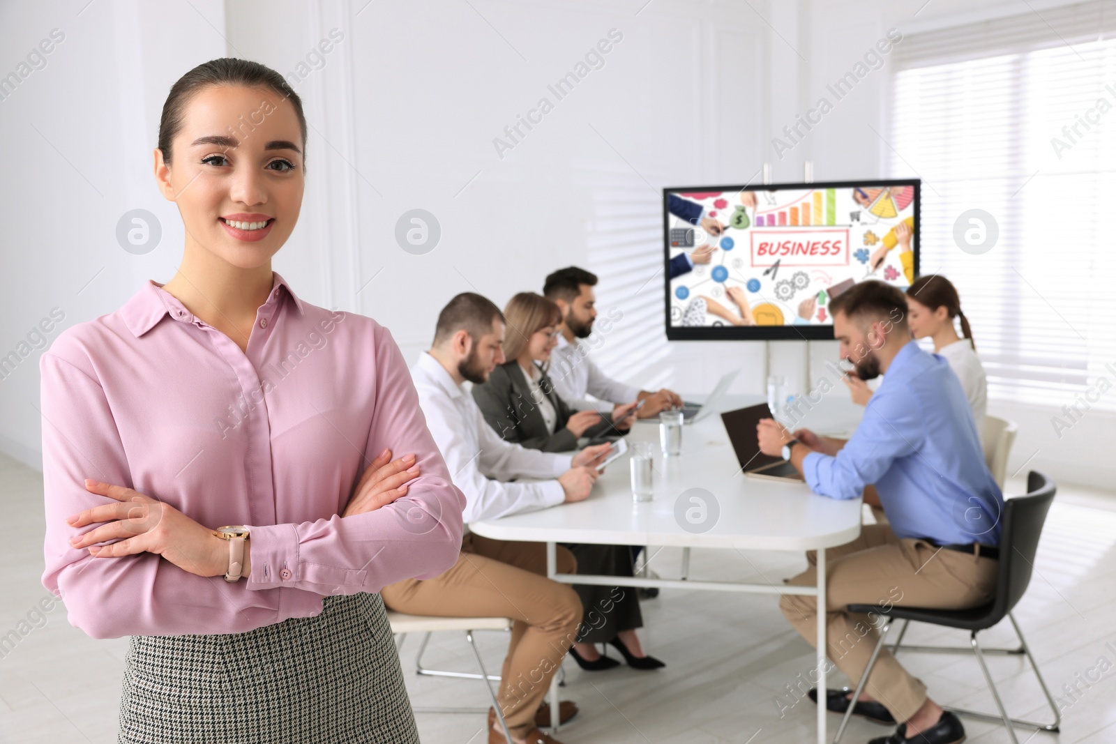 Photo of Business trainer in meeting room with interactive board during presentation