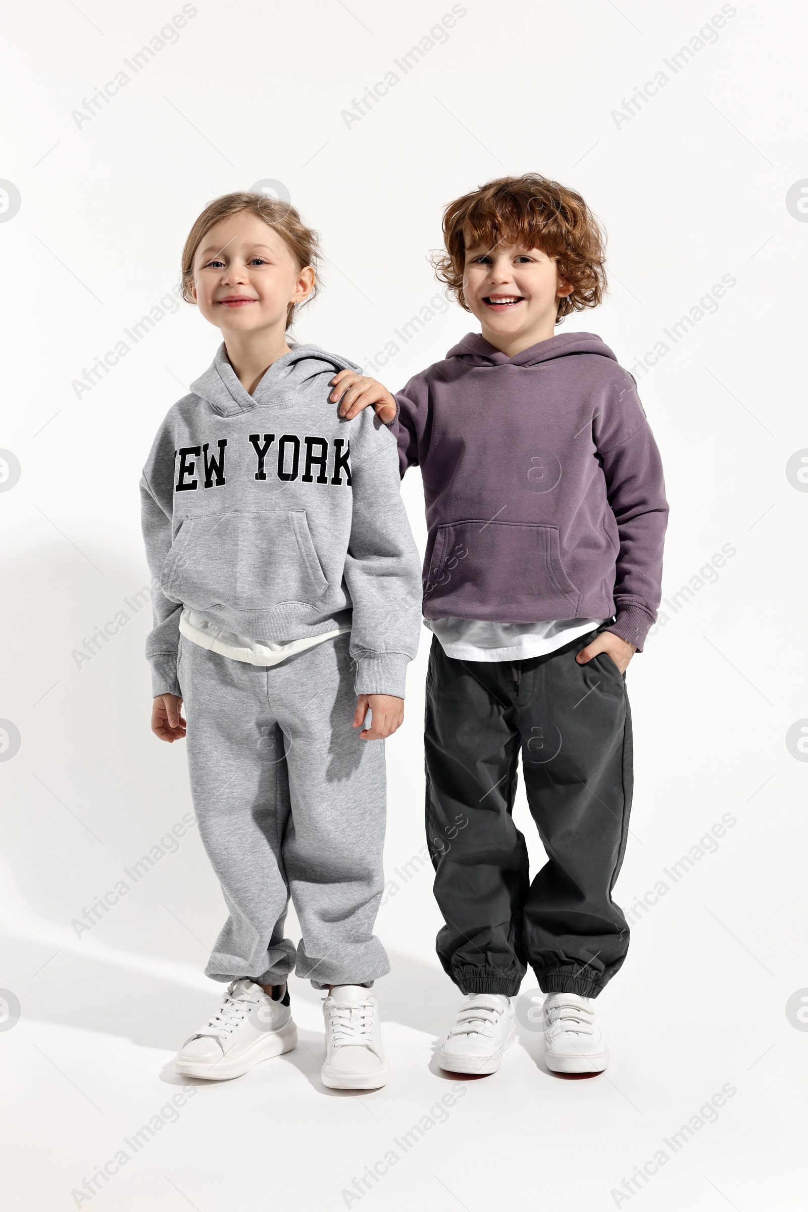 Photo of Fashion concept. Stylish children posing on white background