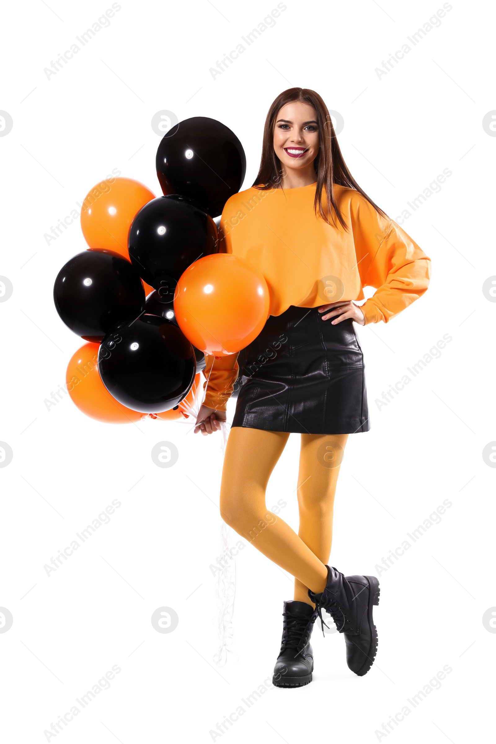 Photo of Beautiful woman with balloons on white background. Halloween party