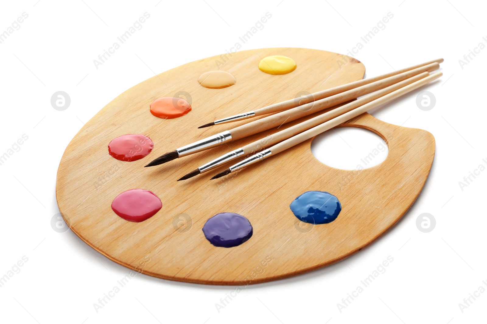 Photo of Palette with paints and brushes on white background