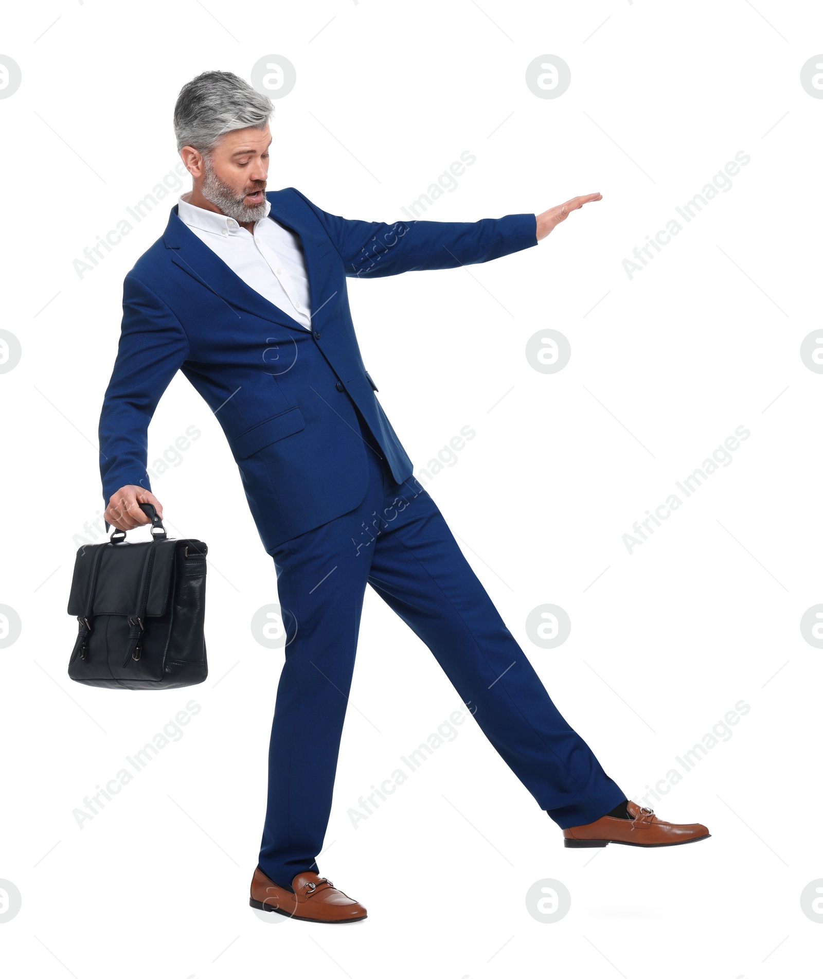 Photo of Mature businessman with briefcase posing on white background