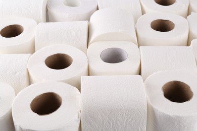 Photo of Many soft toilet paper rolls as background, closeup