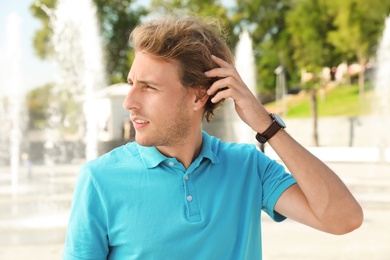 Portrait of handsome young man on street