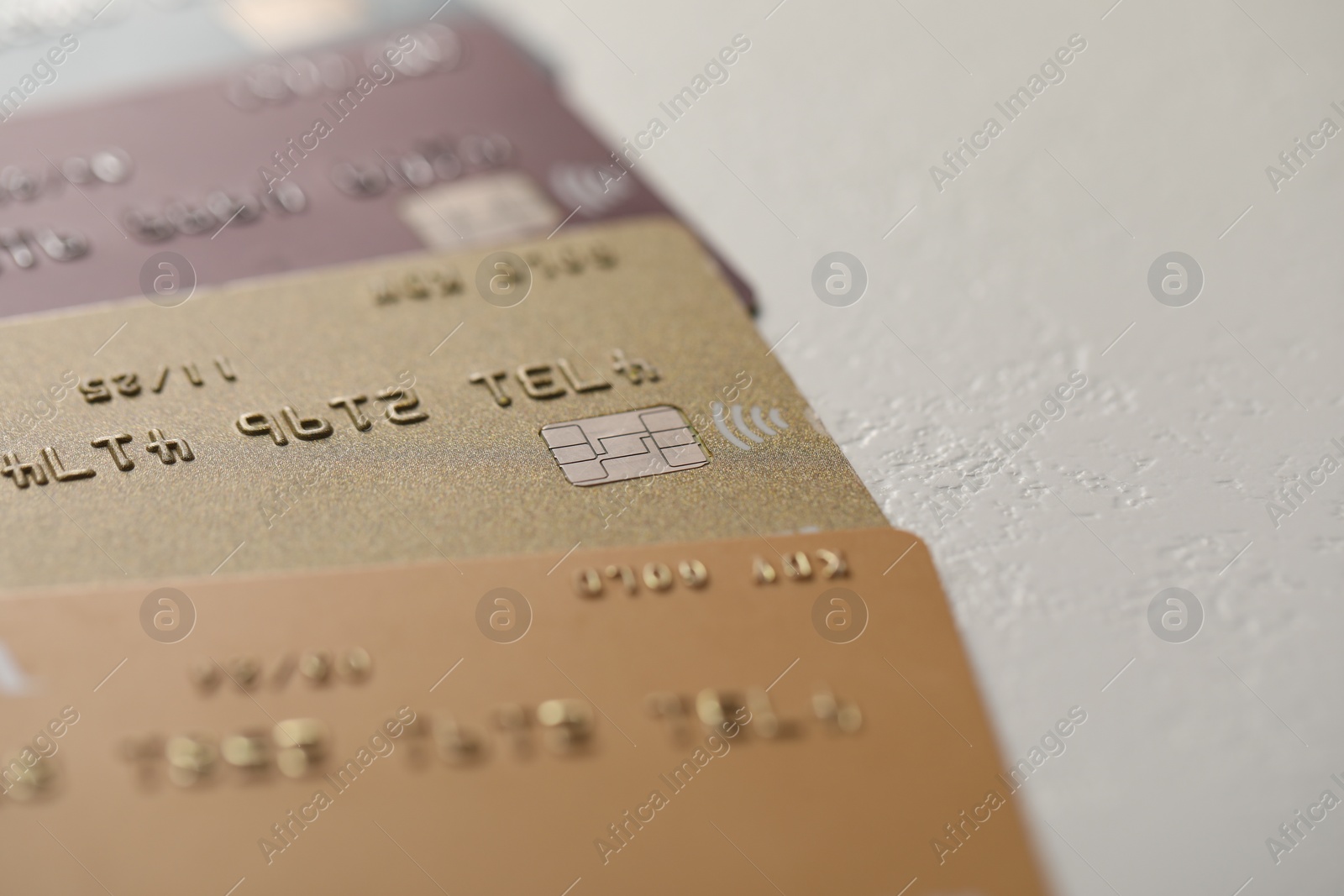 Photo of Many credit cards on gray background, closeup