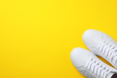 Photo of Pair of sneakers on color background, flat lay. Space for text