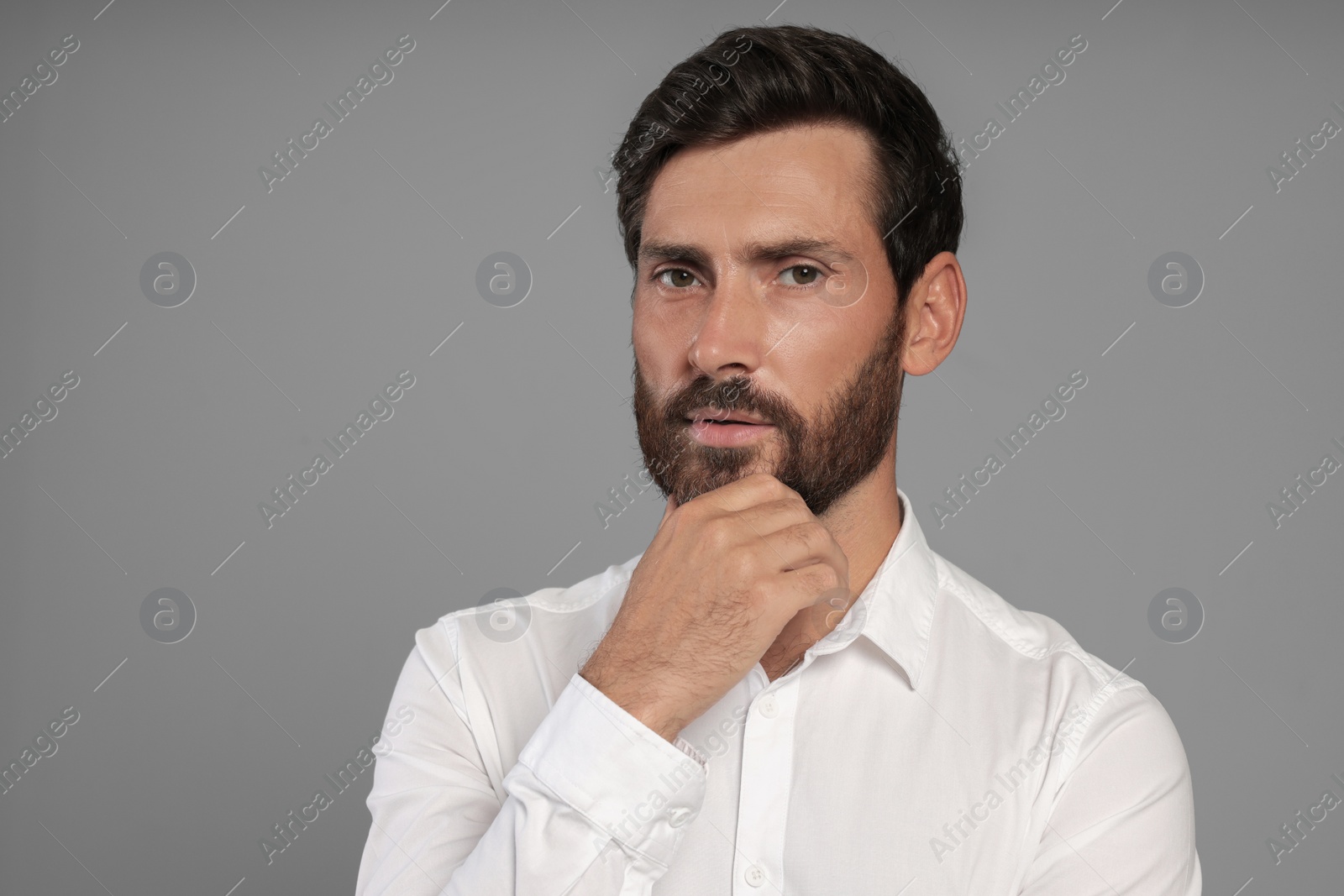 Photo of Portrait of handsome bearded man on grey background, space for text