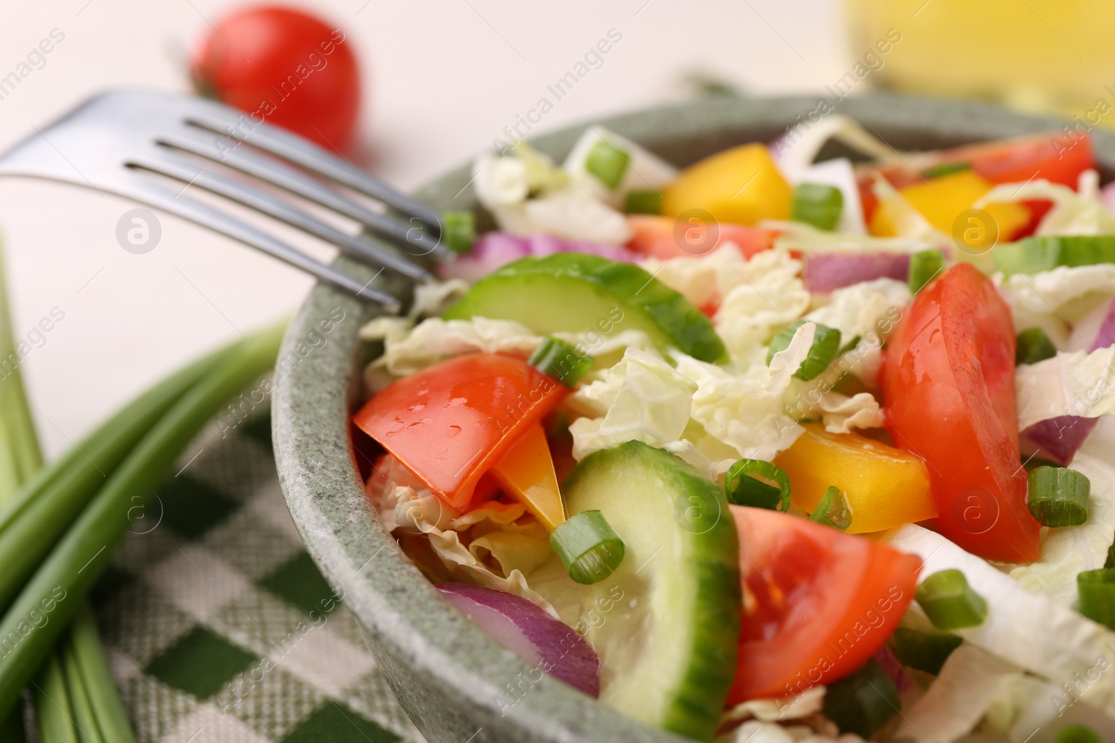 Photo of Tasty salad with Chinese cabbage in bowl on table, closeup