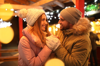 Photo of Happy couple spending time at Christmas fair