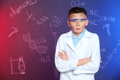 Photo of Emotional pupil against blackboard with written chemistry formulas. Space for text