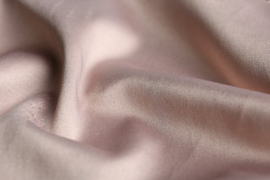 Texture of delicate pink fabric as background, closeup