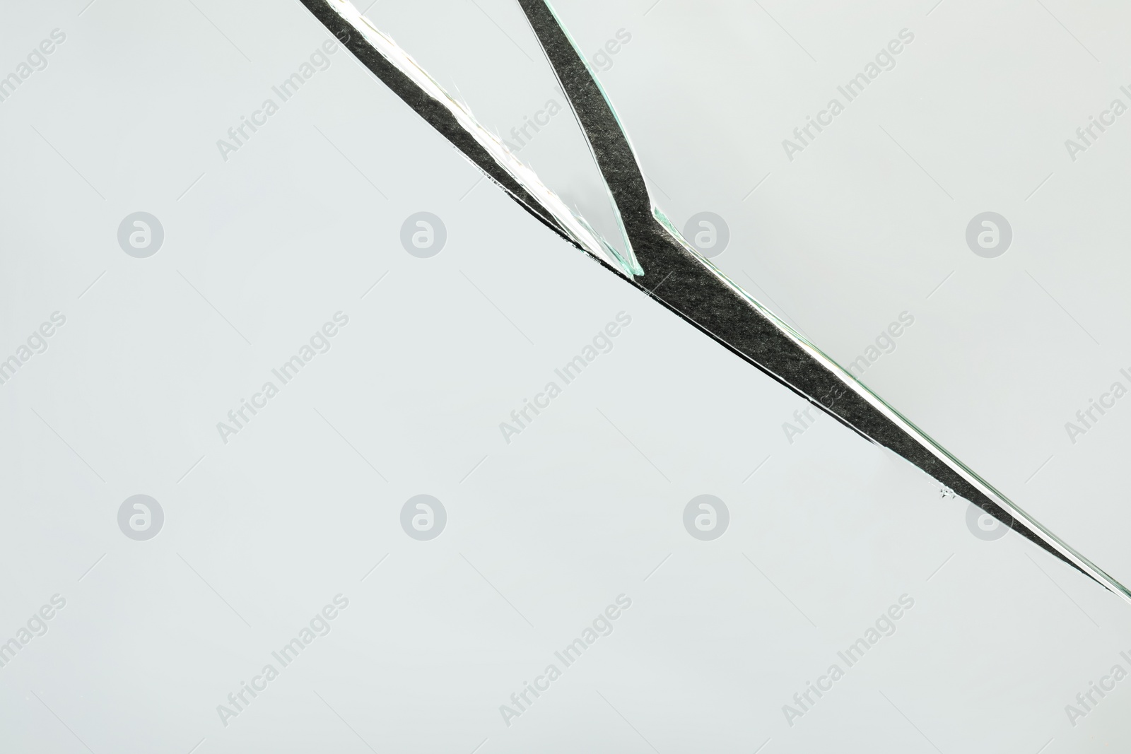 Photo of Shards of broken mirror on dark background, top view