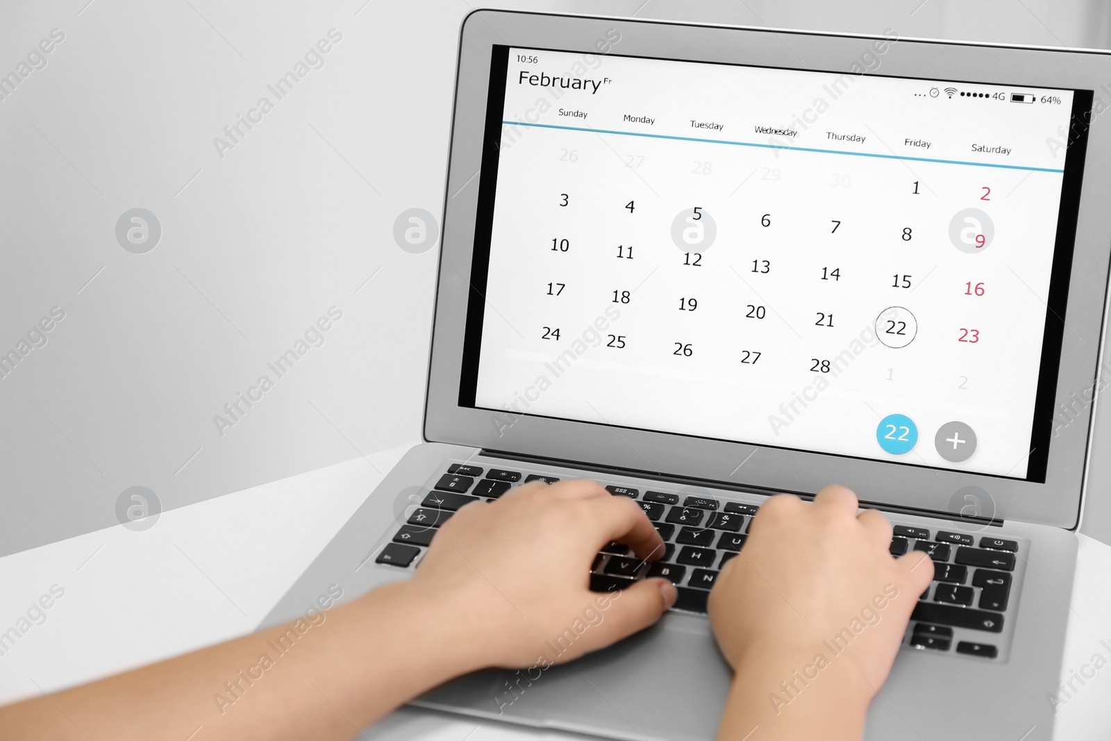 Photo of Woman using digital calendar on laptop in office, closeup