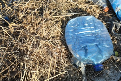 Photo of Different plastic garbage outdoors, space for text. Environmental pollution concept