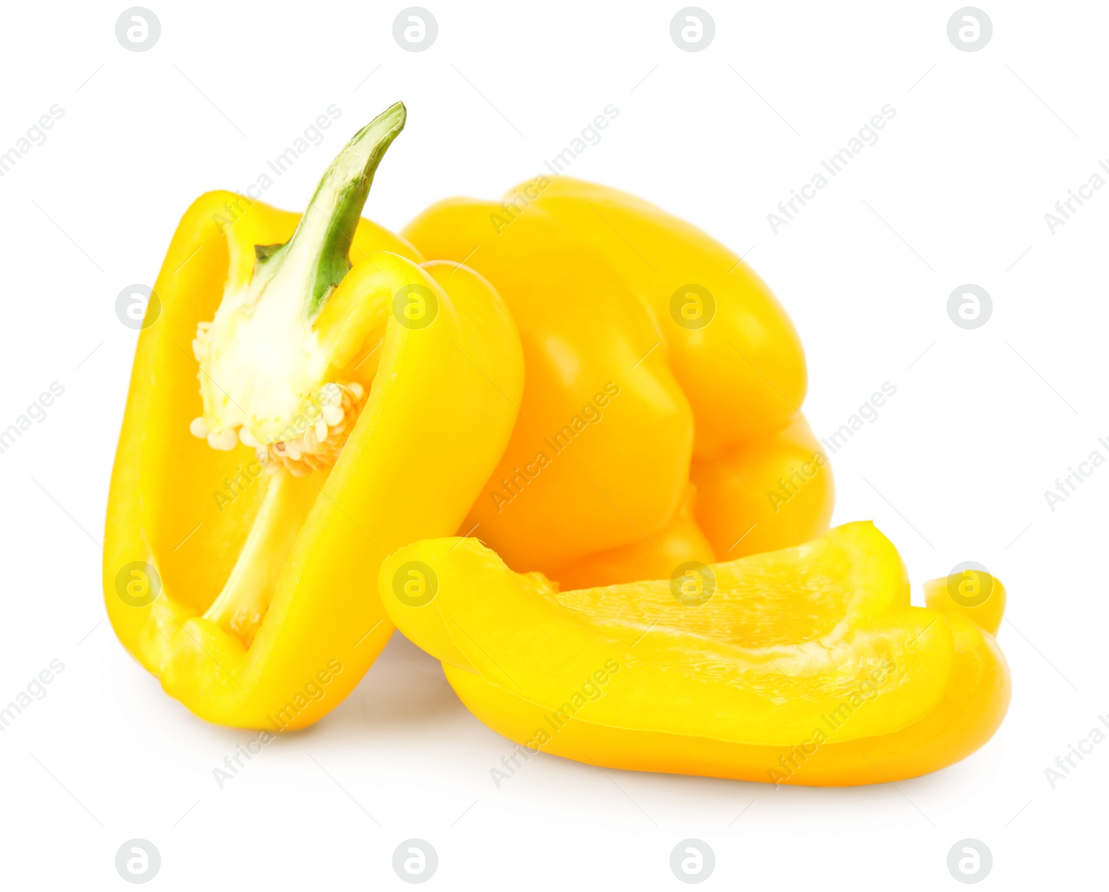 Photo of Whole and cut yellow bell peppers isolated on white