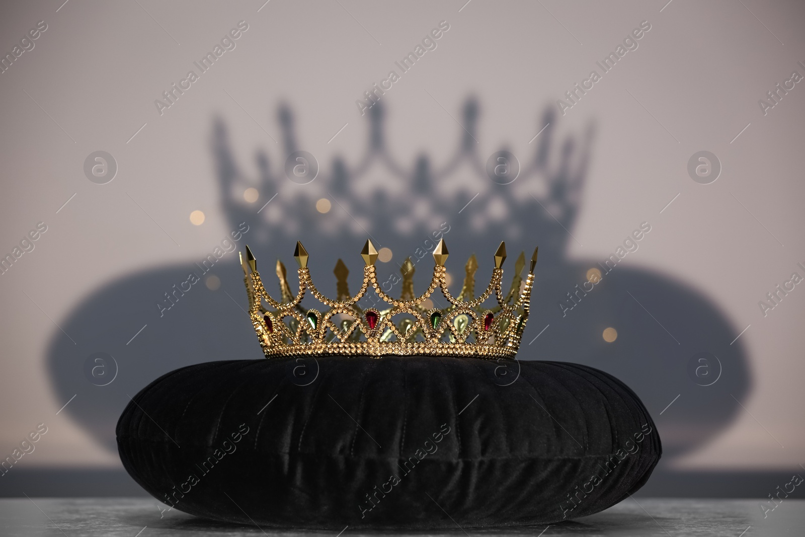Photo of Beautiful gold crown with gems on black pillow