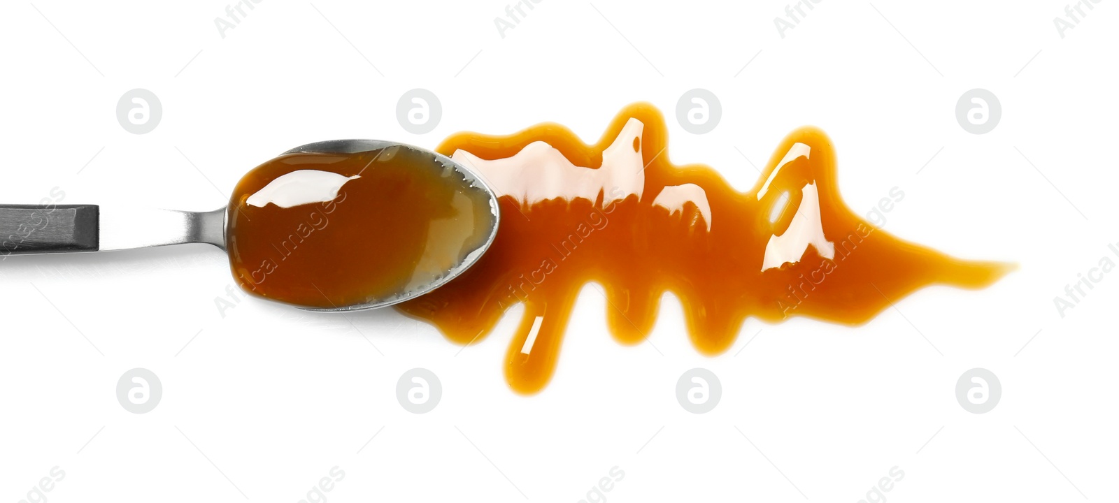 Photo of Spoon with delicious caramel sauce on white background