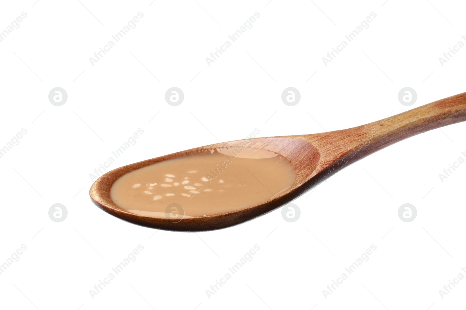 Photo of Spoon of tasty sesame paste isolated on white