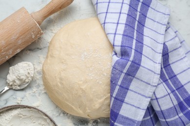 Fresh yeast dough with flour on white marble table, flat lay