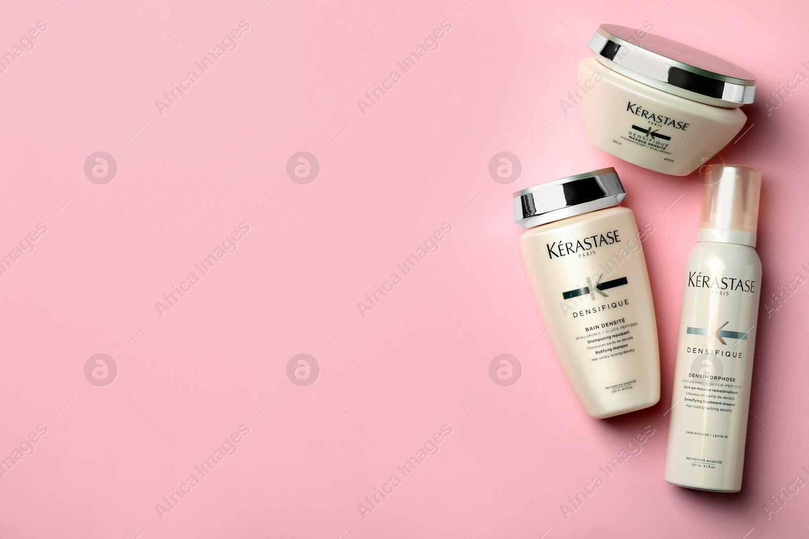 Photo of MYKOLAIV, UKRAINE - SEPTEMBER 07, 2021: Set of  Kerastase hair care cosmetic products on pink background, flat lay. Space for text