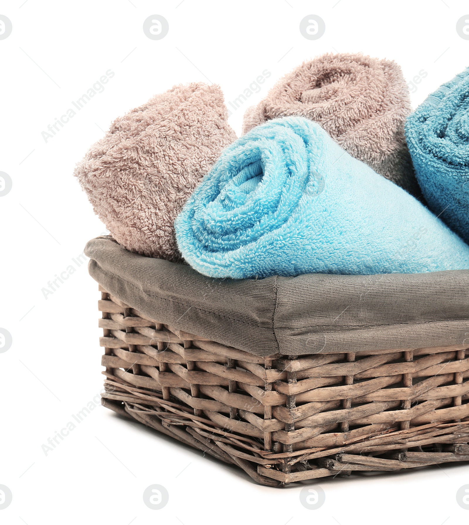 Photo of Basket with clean soft towels on white background