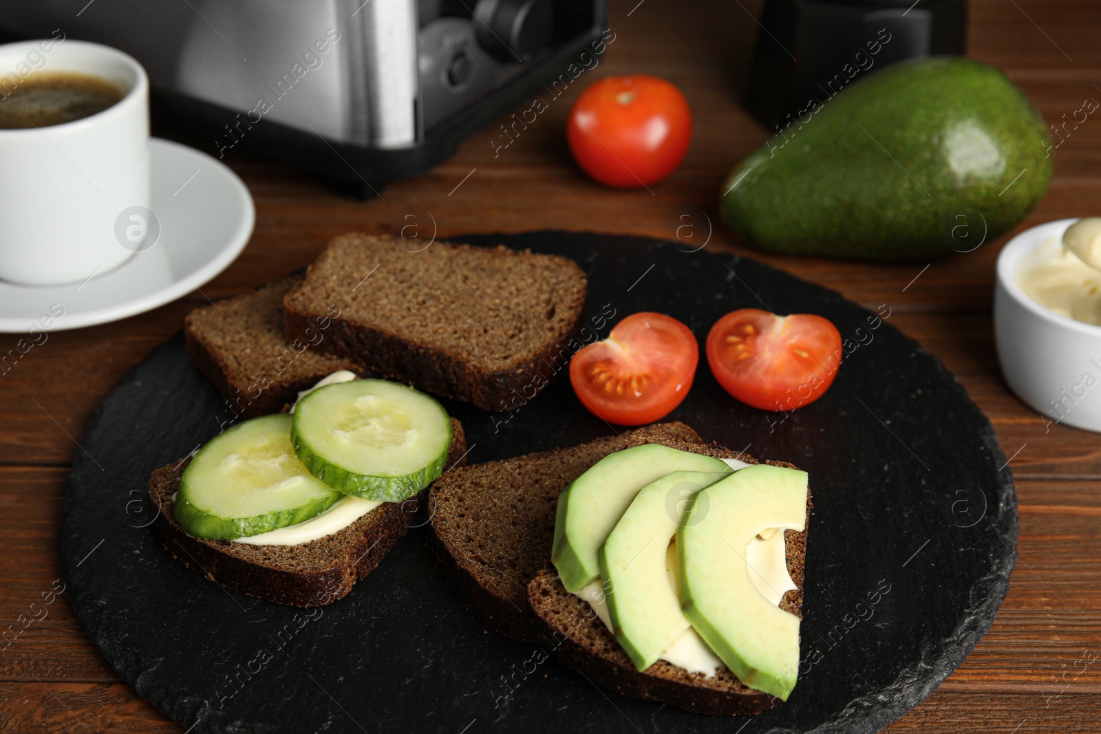 Photo of Slices of bread with different toppings on wooden table