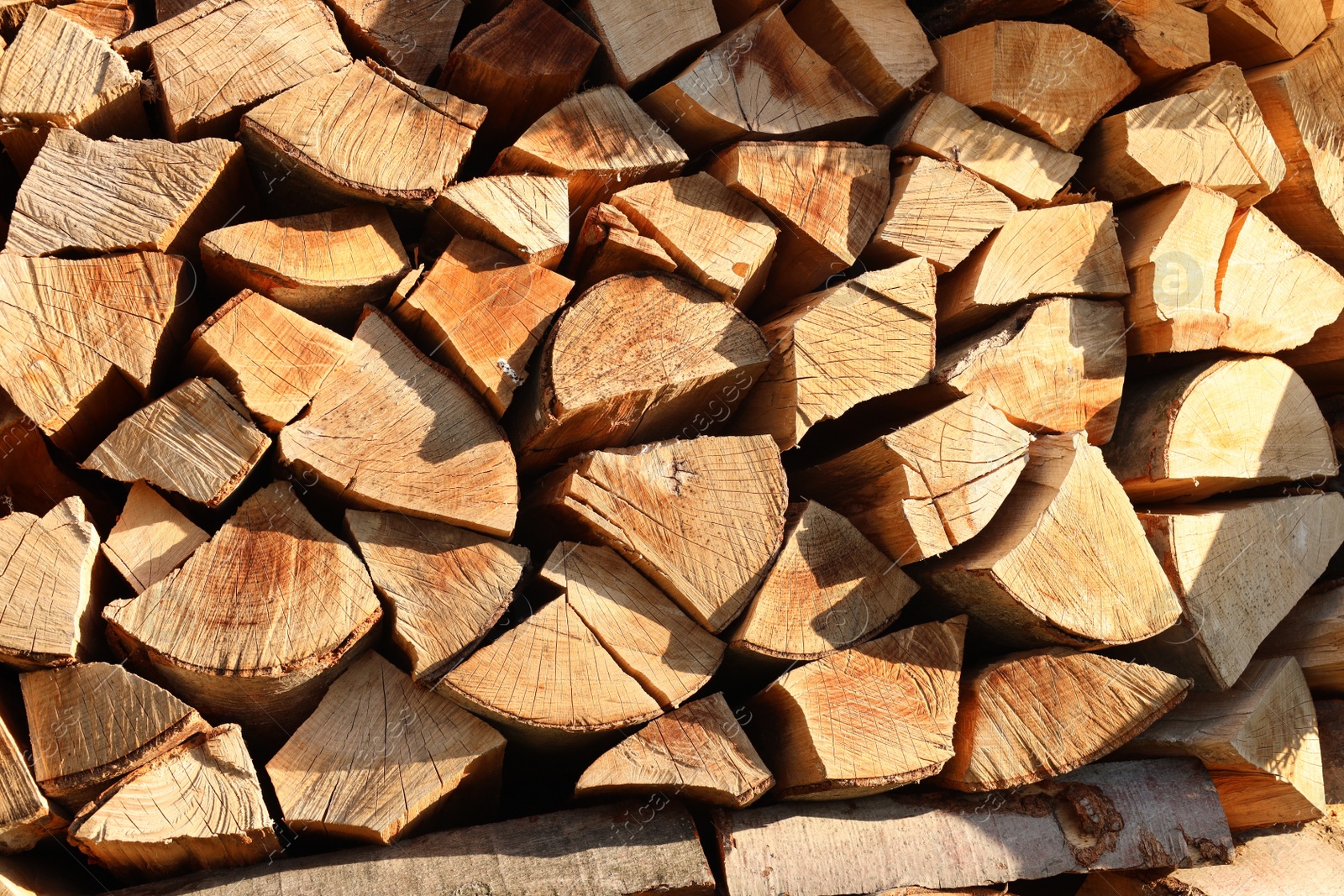 Photo of Stack of chopped firewood as background, closeup