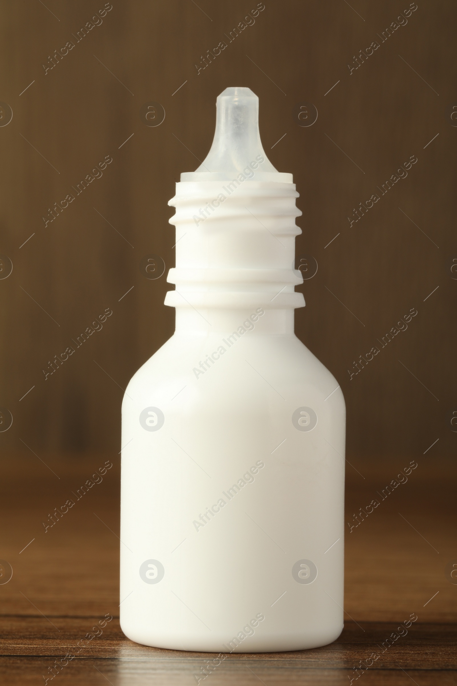 Photo of Bottle of nasal spray on wooden table