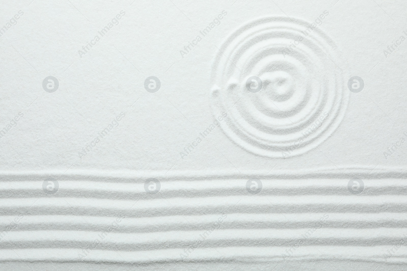 Photo of Top view of white sand with pattern. Zen and harmony